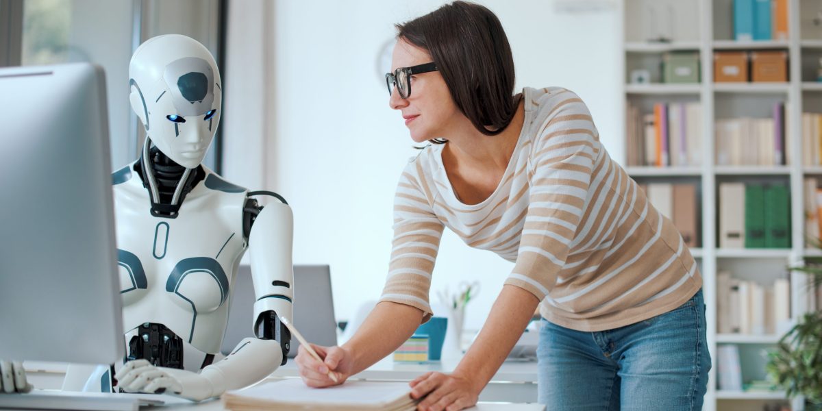 Woman and AI robot working together in the office, automation and technology concept